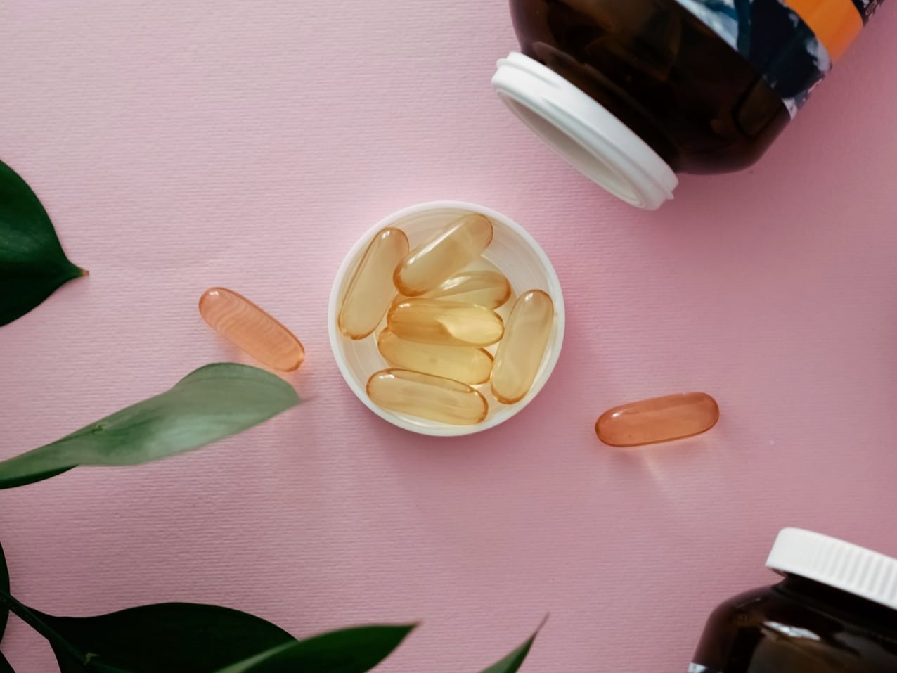 Rows of vitamin and supplement bottles arranged on a shelf